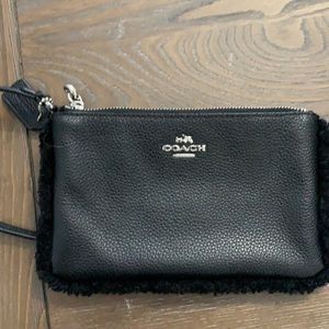 Black leather coach wristlet with fur border